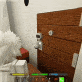 a video game is being played in a room with a wooden wall and a door .