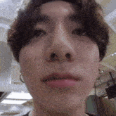 a close up of a person 's face with their mouth open and a very long nose .