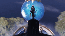 a statue of a man standing on top of a blue globe