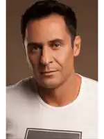a man wearing a white t-shirt with a black square on it