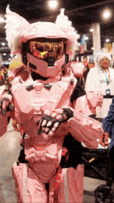 a person dressed in a pink robot costume with a helmet that says halo on it