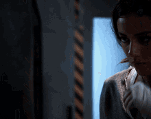 a woman 's face is shown in a dark room