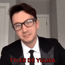 a man wearing glasses and a tuxedo with the name tyler de yulisa on the bottom
