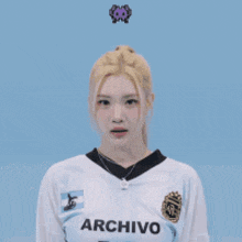 a woman wearing a white archivo 10 jersey throws a butterfly in the air