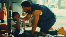 a man kneeling down next to a little girl with the words ironheart written on the bottom