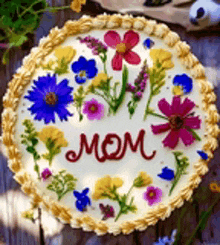 a cake with flowers on it and the word mom on it