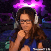 a woman wearing glasses and headphones with the words sweettails written below her
