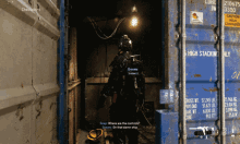 a video game character named graves is standing next to a blue shipping container