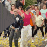 a group of people are dancing in front of a crowd of people .