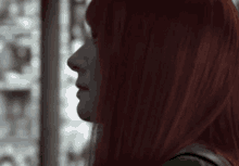 a close up of a woman with red hair