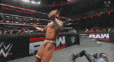 a wrestling match is being played in front of a sign that says w