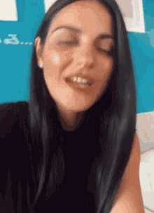 a close up of a woman 's face with her eyes closed and her mouth open