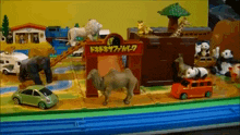 a toy set with animals and a sign that says " safari park " on it