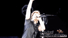 a man singing into a microphone with the words bon jovi motijheel dhaka written on the bottom