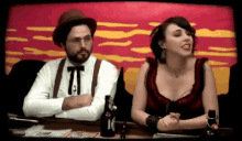 a man and a woman are sitting at a table with a bottle that says 10