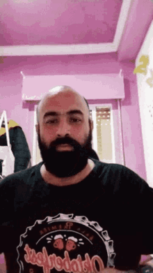 a bald man with a beard is wearing a black t-shirt that says jugopodado on it