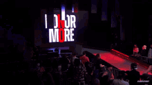 a crowd of people watching a wrestling match with the words honor more on the screen