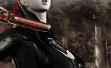 a woman is holding a red sword in her right hand