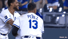 two baseball players one of whom is wearing the number 13