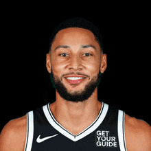 a basketball player wearing a jersey that says get your guide on it
