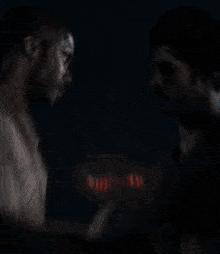 a painting of a man kissing another man with the word love written in red