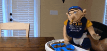 a puppet with a bib that says get a bib on it