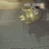 a yellow cartoon character with big eyes and sharp teeth is standing in a room .
