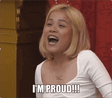 a woman is laughing and says i 'm proud !!!