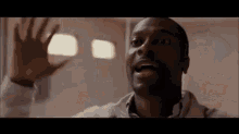 a man in a white shirt is making a funny face