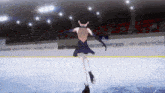 a girl in a black dress is skating on a rink