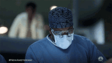 a surgeon is wearing a mask and glasses with the hashtag #newamsterdam