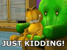 garfield sits in a green chair with the words just kidding
