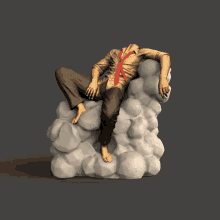a statue of a man sitting on a pile of rocks with his head missing