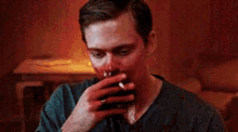 a man with blood on his face is smoking a cigarette and has blood on his face .