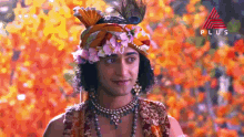 a close up of a person wearing a turban with flowers on it .