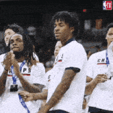a group of basketball players are clapping their hands while wearing white shirts with ch on them