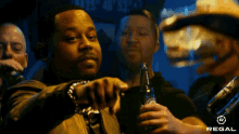 a man holds a bottle of regal beer in his right hand