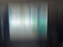 a blurred image of a window with blinds on