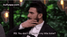 a man in a suit and tie is talking to another man in a suit and tie .