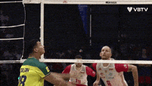 a volleyball player with the number 19 on his shirt is getting ready to serve the ball