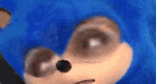 a close up of a sonic the hedgehog 's face with a blue background .