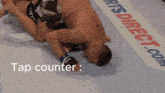 a man laying on the ground with a sports direct.com banner in the background