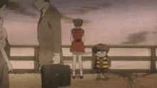 a group of people are standing next to each other on a bridge . one of the people is holding a briefcase .