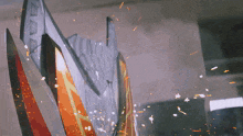 a close up of a shield with a few sparks flying around it