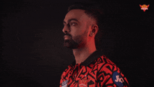 a man in a red and black shirt with jio on his arm