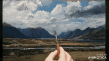 a person is painting a landscape with the words made in animotica below