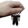 a pixel art of a hand holding a small cartoon character .