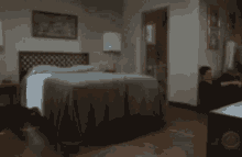a blurry picture of a bedroom with a large bed