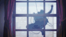 a person is hanging from a window with a rope