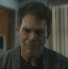 a close up of a man 's face with sweat running down his forehead